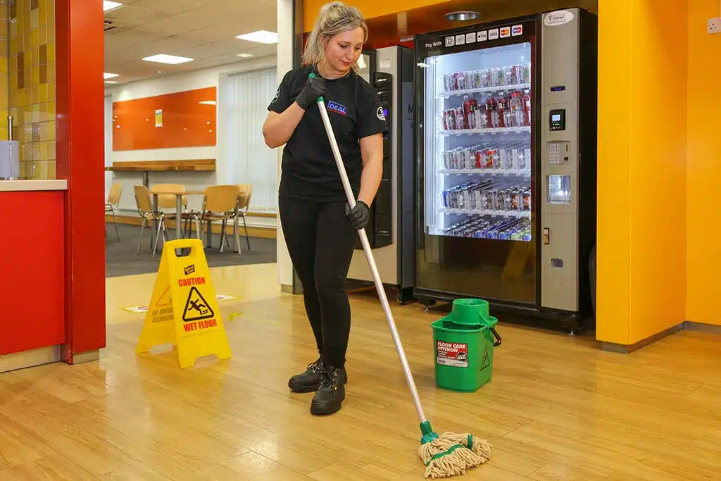 Cleaning Sign And Woman Mopping Floor In Office For Hygiene Health